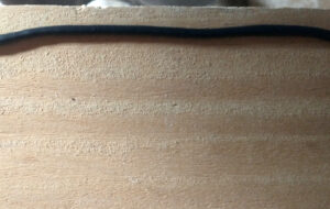 Laying a bead of black polyurethane to help create a weather tight seal between the mounting surface and the boot.