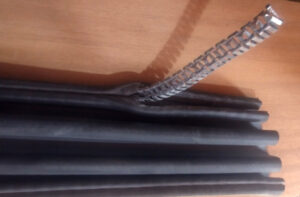 Show the metal clip being removed from the rubber.