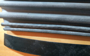 Side by side showing the accordion boot without metal clip next to the vinyl stiffing insert to be install